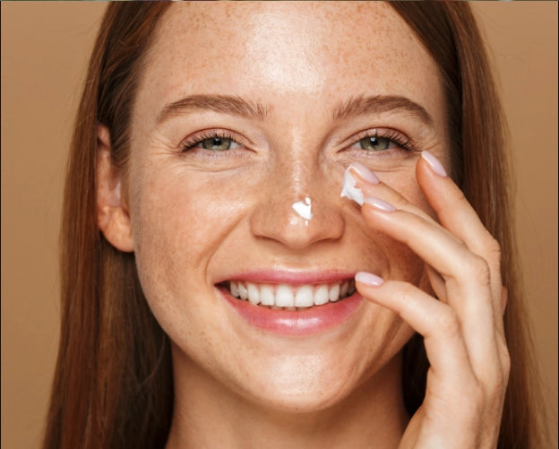 Woman applying facial cream