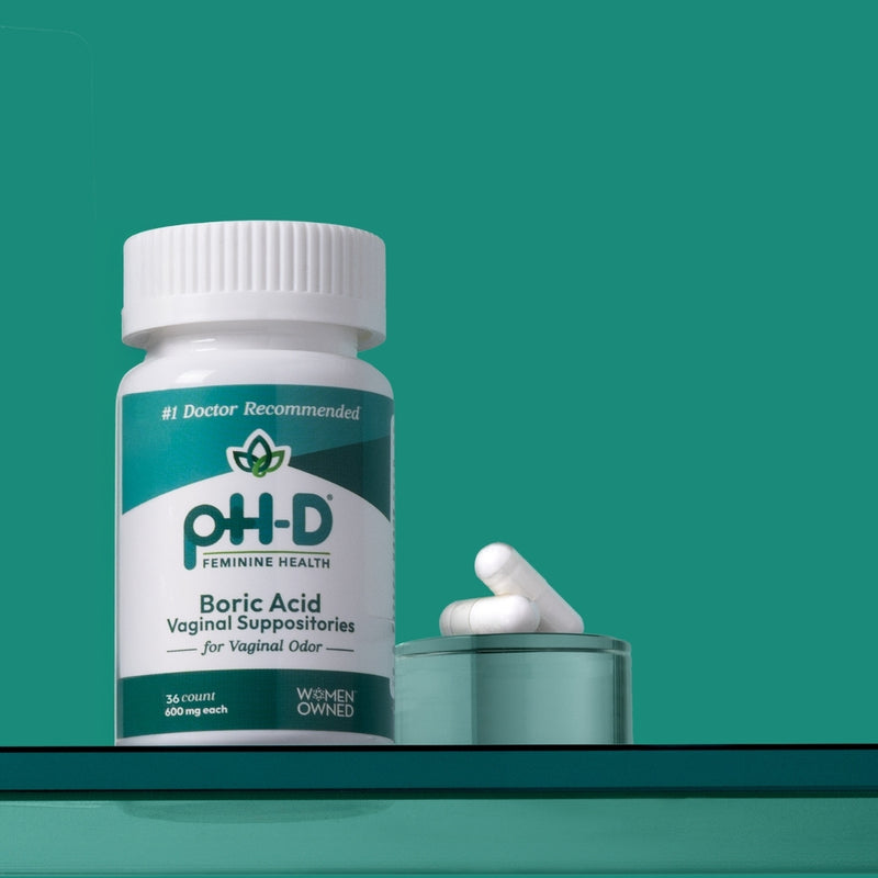 PH-D Feminine Health Boric Acid Vaginal Suppositories bottle on a green background